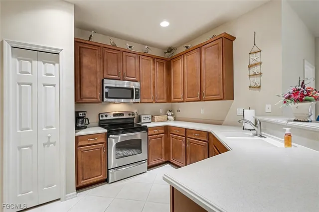 a kitchen with stainless steel appliances granite countertop a sink dishwasher stove and oven