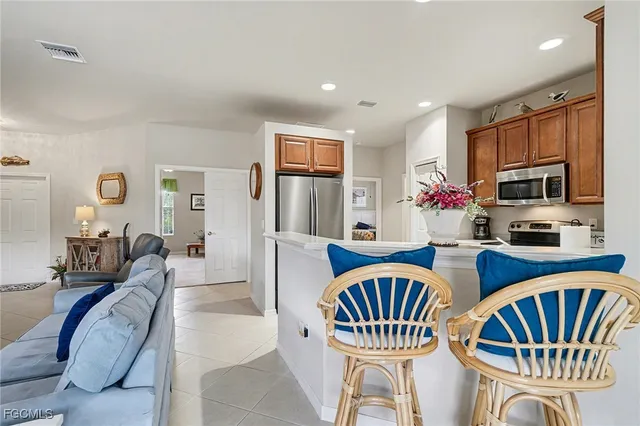 a living room with furniture and a kitchen