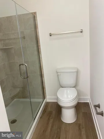a bathroom with a toilet and a shower