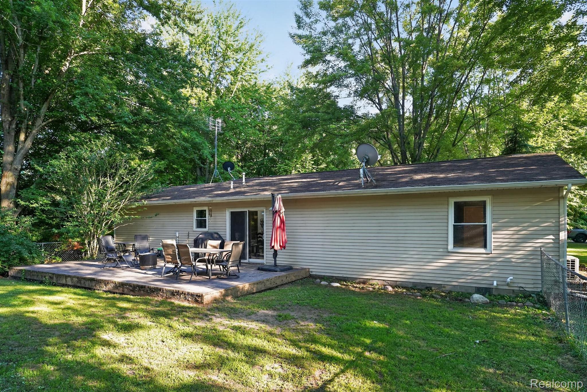 8696 West Sargent Road Fowlerville, MI 48836 - Photo 31 of 36 Spacious raised patio with sliding glass door access