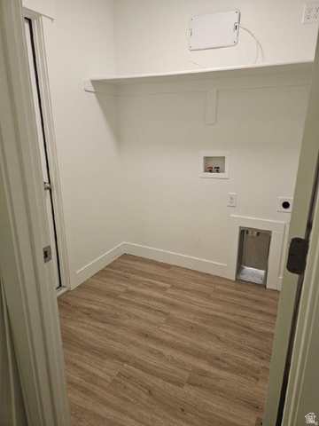 929 North 960 West Tremonton, UT 84337 - Photo 8 of 20 Dedicated utility room featuring wood-finish flooring, crisp white walls, and a built-in storage shelf