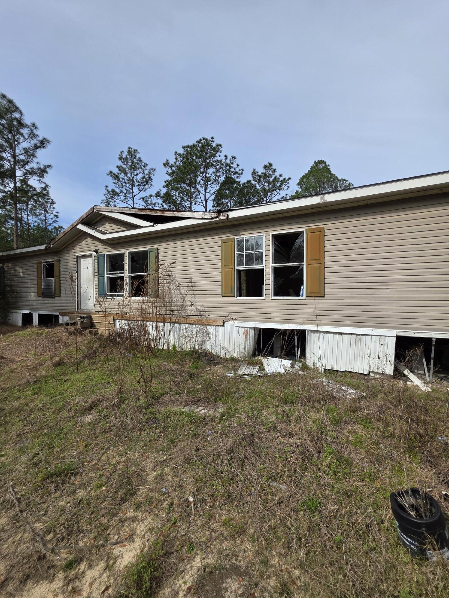 1921 Cotton Creek Road Baker, FL 32531 - Photo 2 of 2 a front view of a house with a yard
