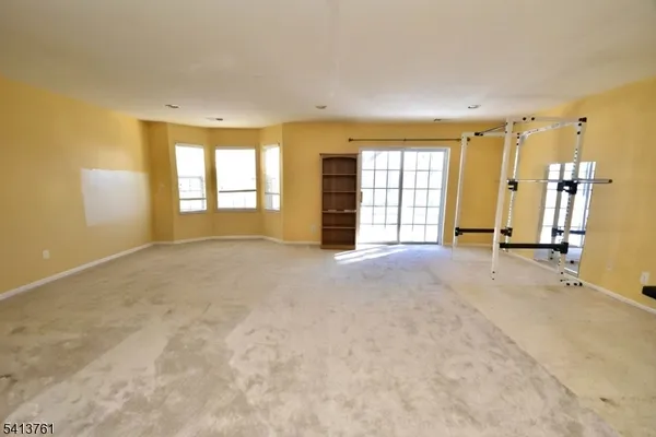 a view of empty room with a fireplace