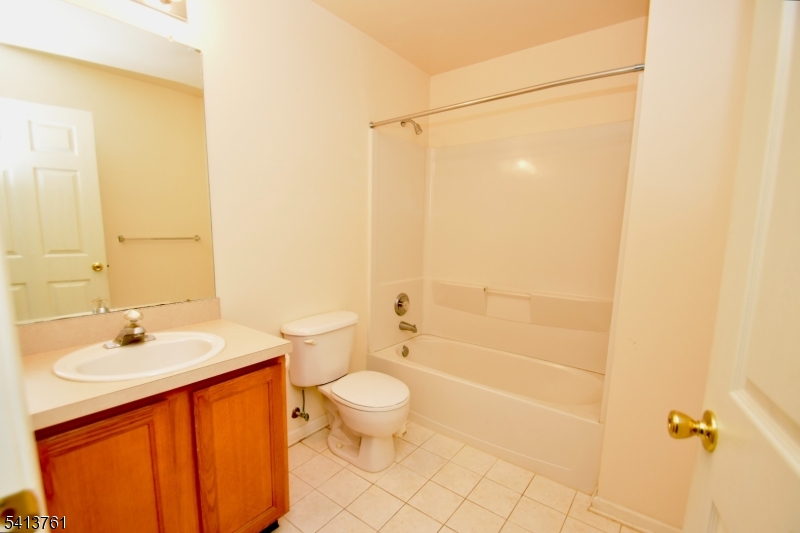 263 Ridge Drive Pompton Lakes, NJ 07442 - Photo 17 of 20 a bathroom with a sink a toilet and shower