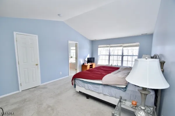 a bed room with a bed window and a lamp