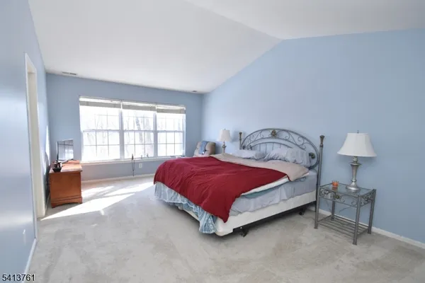 a spacious bedroom with a bed and a couch