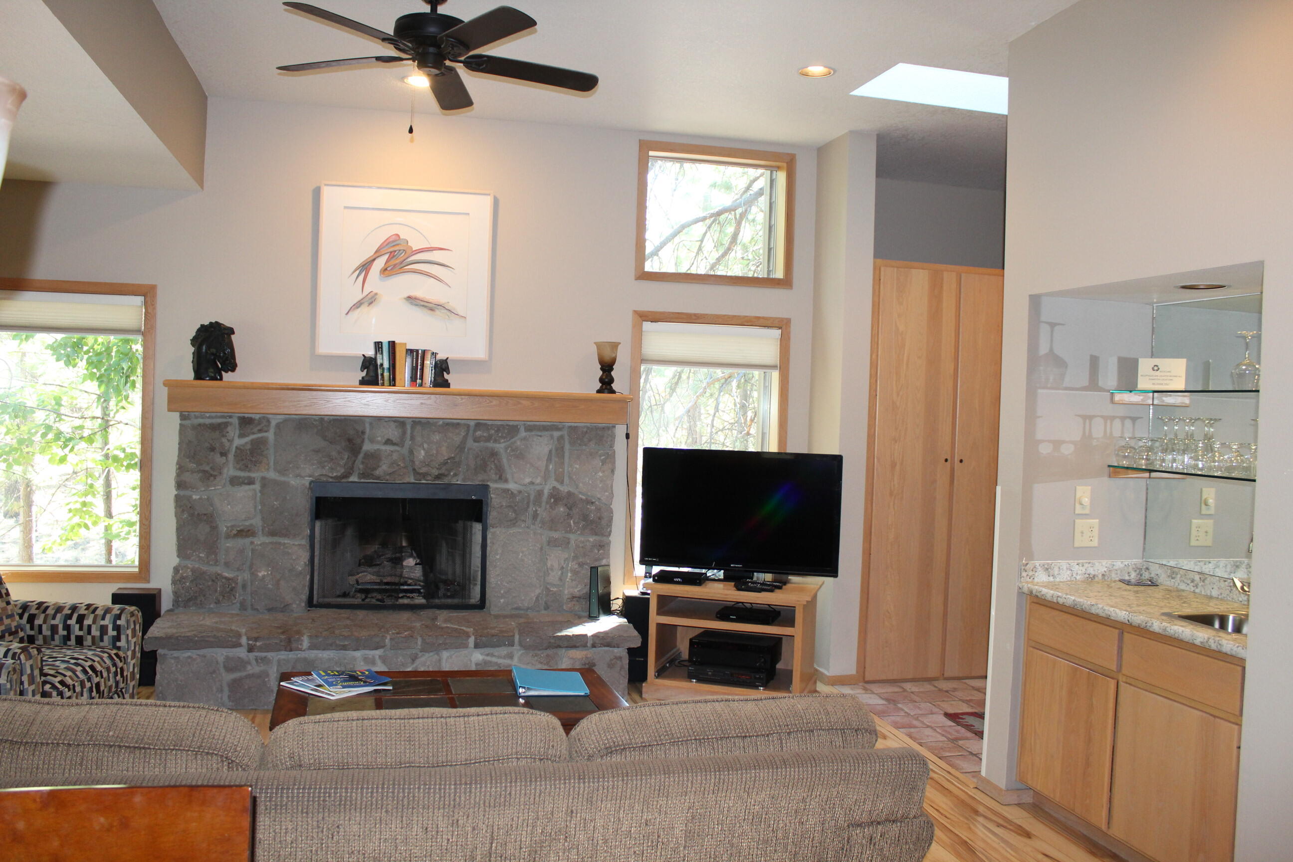 57407-44c Beaver Ridge Loop Sunriver, OR 97707 - Photo 7 of 24 a living room with furniture a flat screen tv and a fireplace