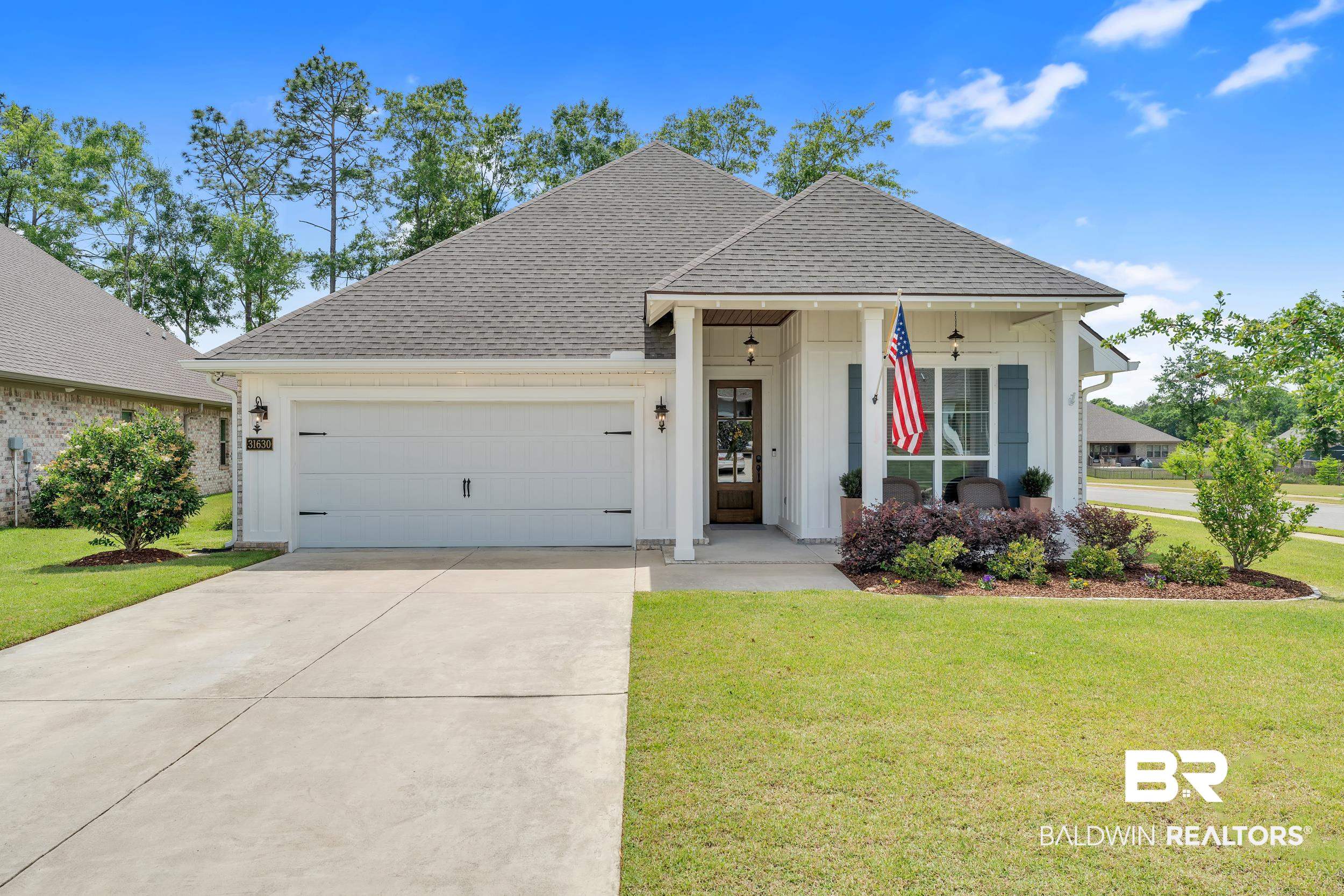 31630 Canopy Loop Daphne, AL 36527 - Photo 1 of 30 View of front of home featuring an attached garage, driveway, a shingled roof, and a front yard
