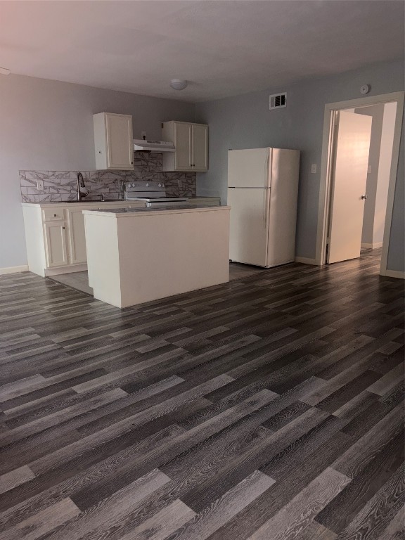 4626 Bell Street, Unit 6 Houston, TX 77023 - Photo 1 of 11 a kitchen with granite countertop a refrigerator and a stove top oven
