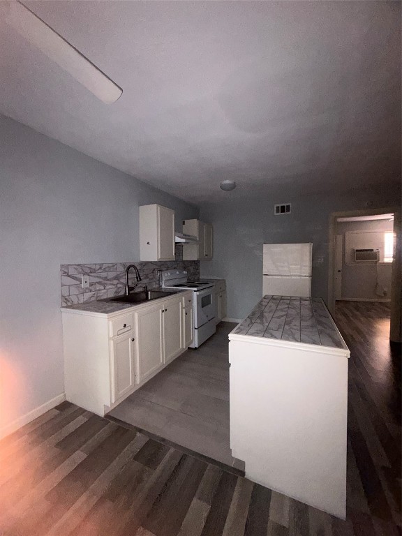 4626 Bell Street, Unit 6 Houston, TX 77023 - Photo 2 of 11 a kitchen with a sink a stove and cabinets