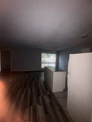 a view of a room with wooden floor and windows