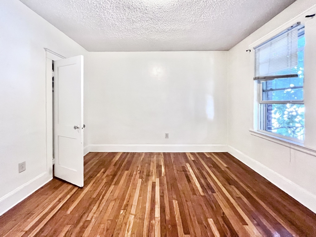 26 Chiswick Road, Unit 6 Boston, MA 02135 - Photo 18 of 31 a view of wooden floor in a room