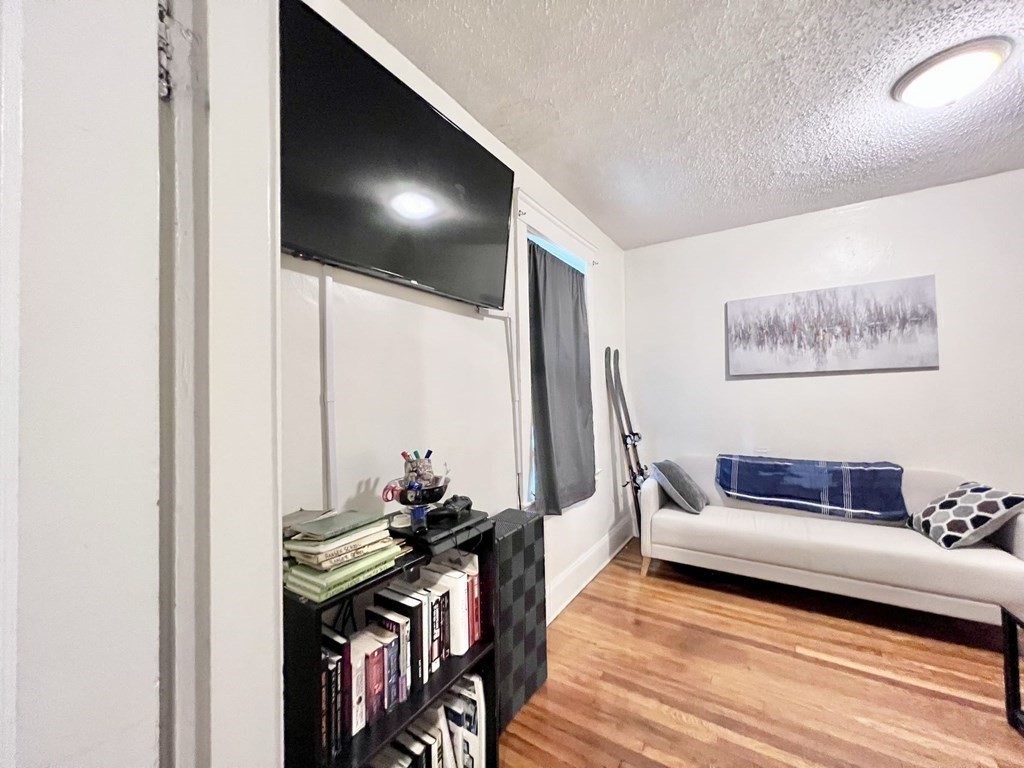 26 Chiswick Road, Unit 6 Boston, MA 02135 - Photo 23 of 31 a living room with furniture and wooden floor