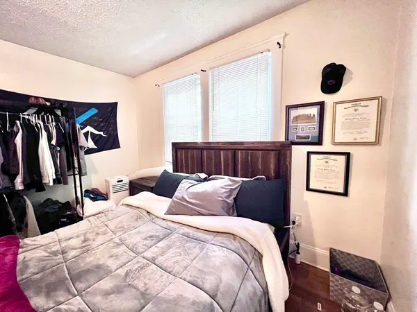 a bedroom with bed and a window