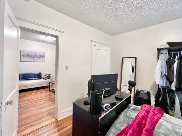 a view of a bedroom with bed and workspace