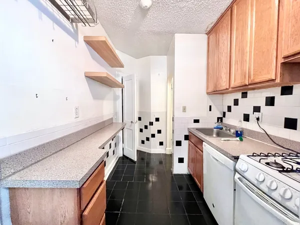 a kitchen with stainless steel appliances a stove a sink and a refrigerator