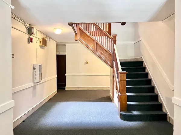 a view of entryway with stairs and wooden floor