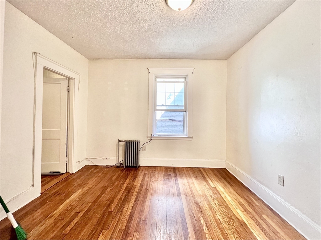 26 Chiswick Road, Unit 6 Boston, MA 02135 - Photo 8 of 31 a view of empty room with wooden floor
