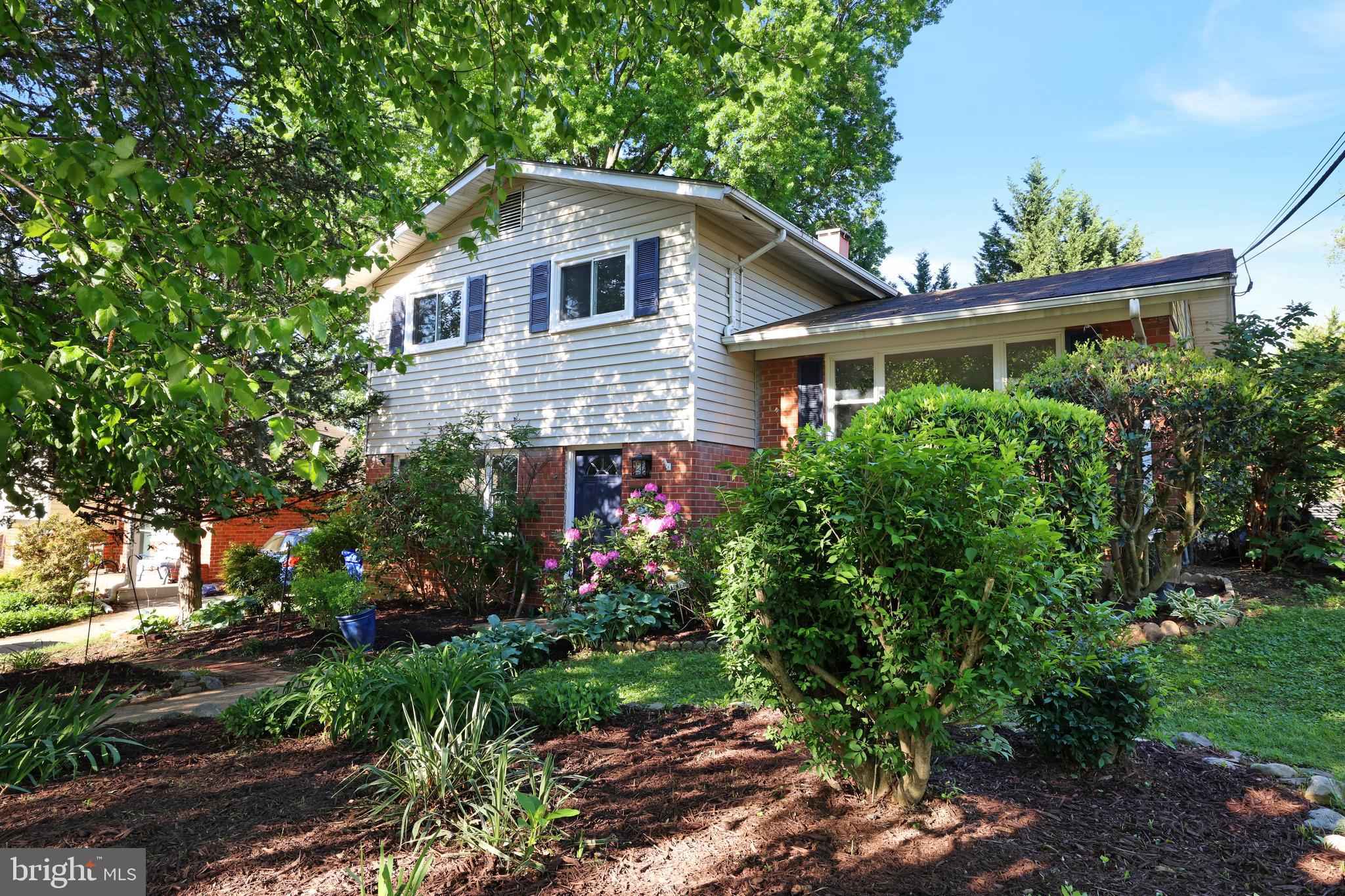a front view of house with a garden