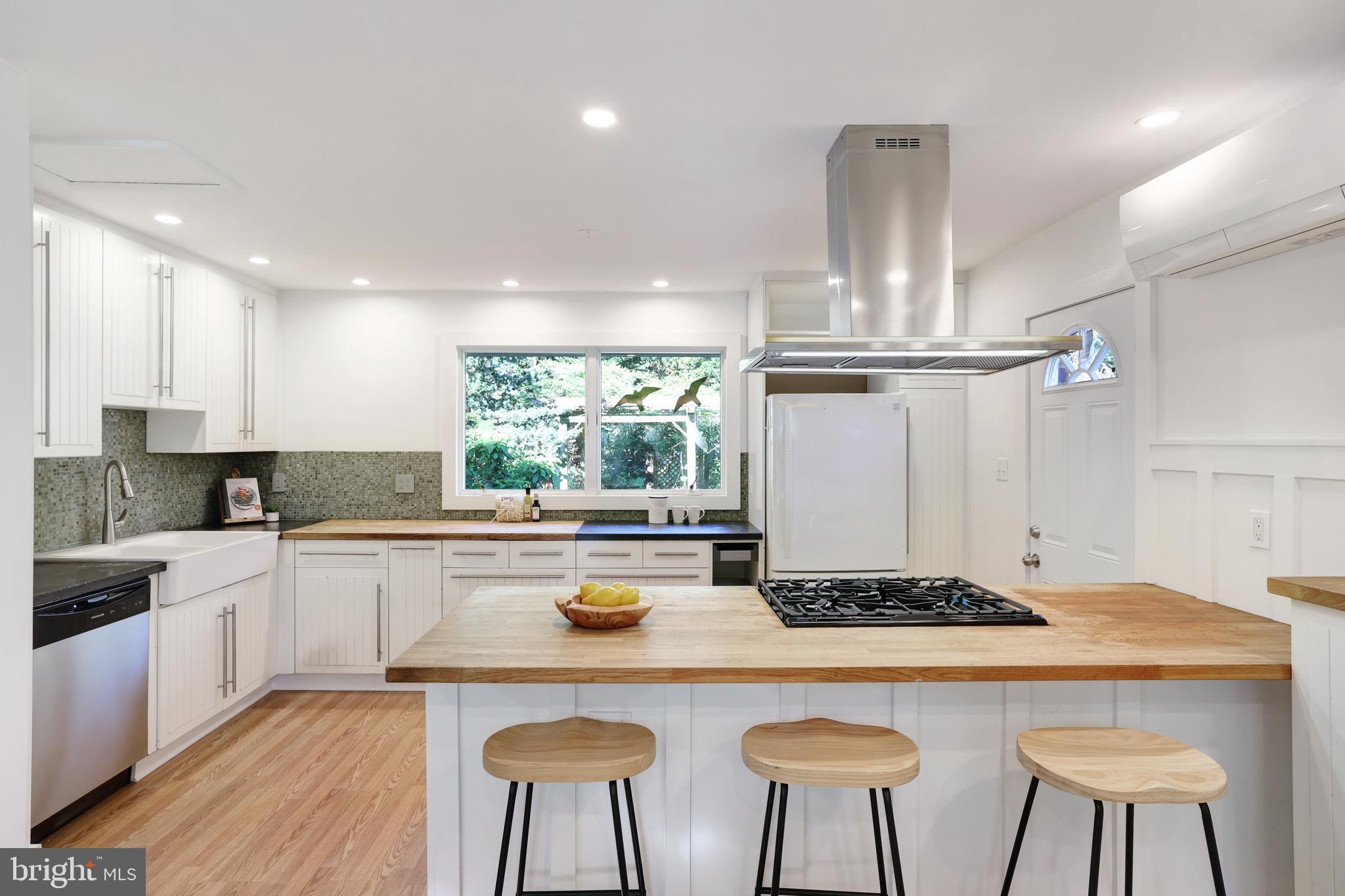 11812 Selfridge Road Silver Spring, MD 20906 - Photo 12 of 42 a kitchen with a dining table chairs sink and cabinets