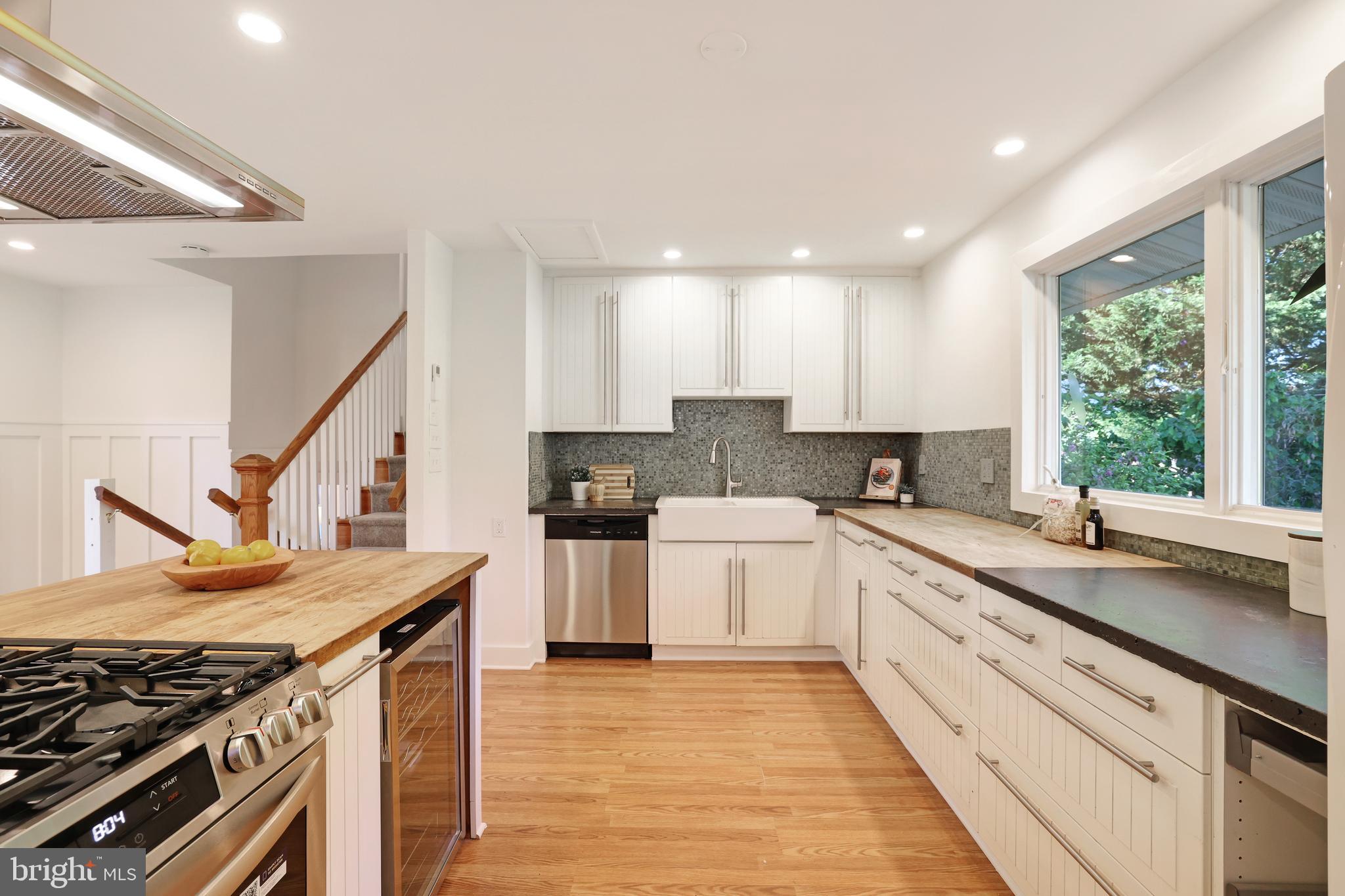 11812 Selfridge Road Silver Spring, MD 20906 - Photo 15 of 42 a kitchen with a sink stove and cabinets