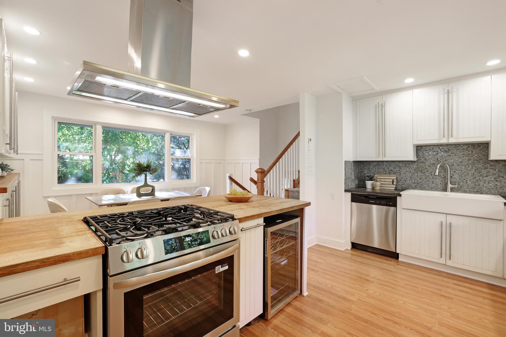 11812 Selfridge Road Silver Spring, MD 20906 - Photo 17 of 42 a kitchen with a stove a sink and wooden floor