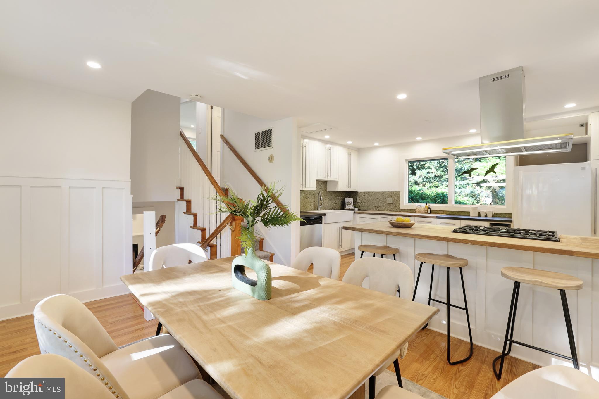 11812 Selfridge Road Silver Spring, MD 20906 - Photo 21 of 42 a kitchen with stainless steel appliances granite countertop a table chairs sink and cabinets