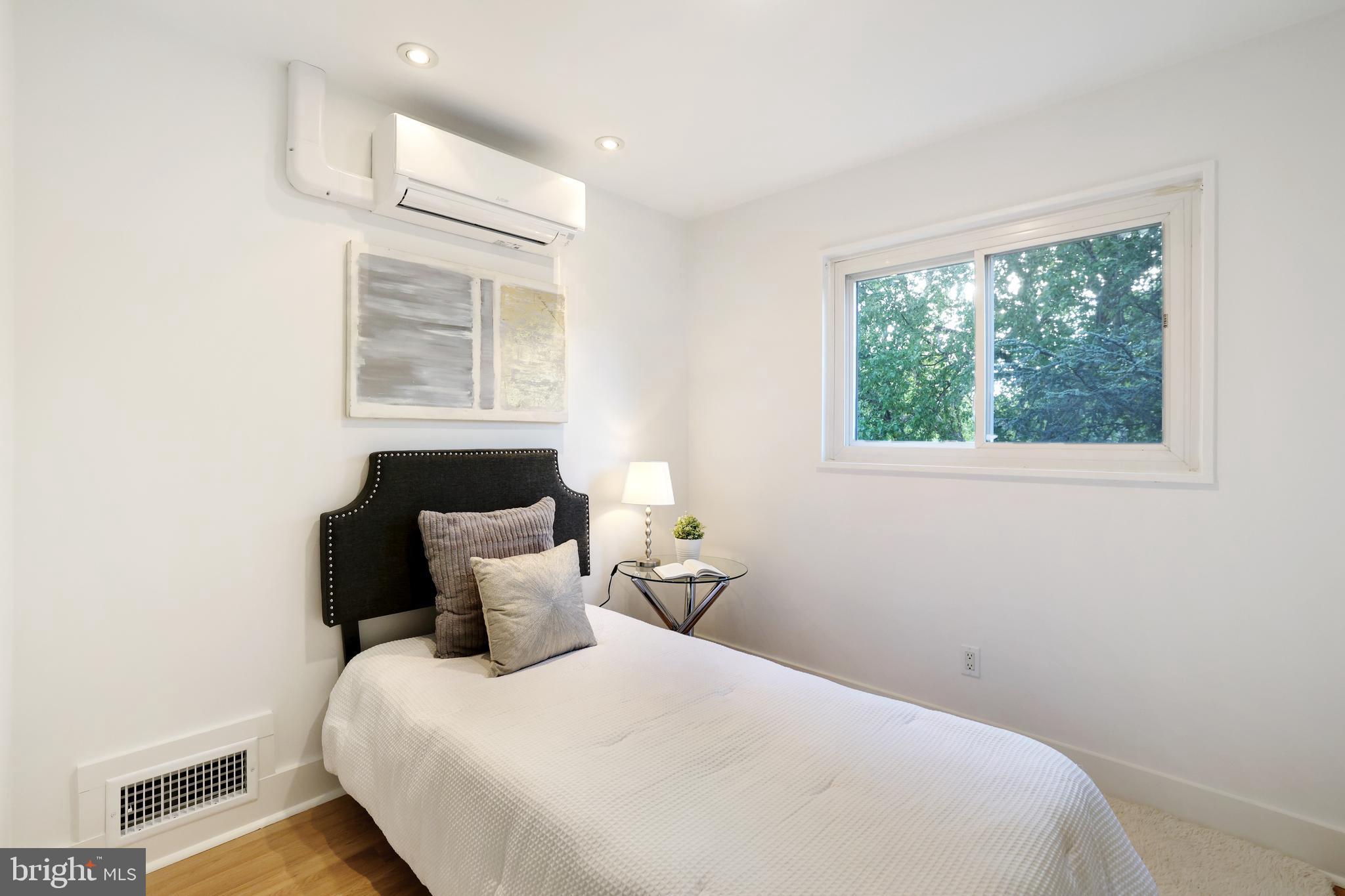 11812 Selfridge Road Silver Spring, MD 20906 - Photo 28 of 42 a bedroom with a bed and wooden floor