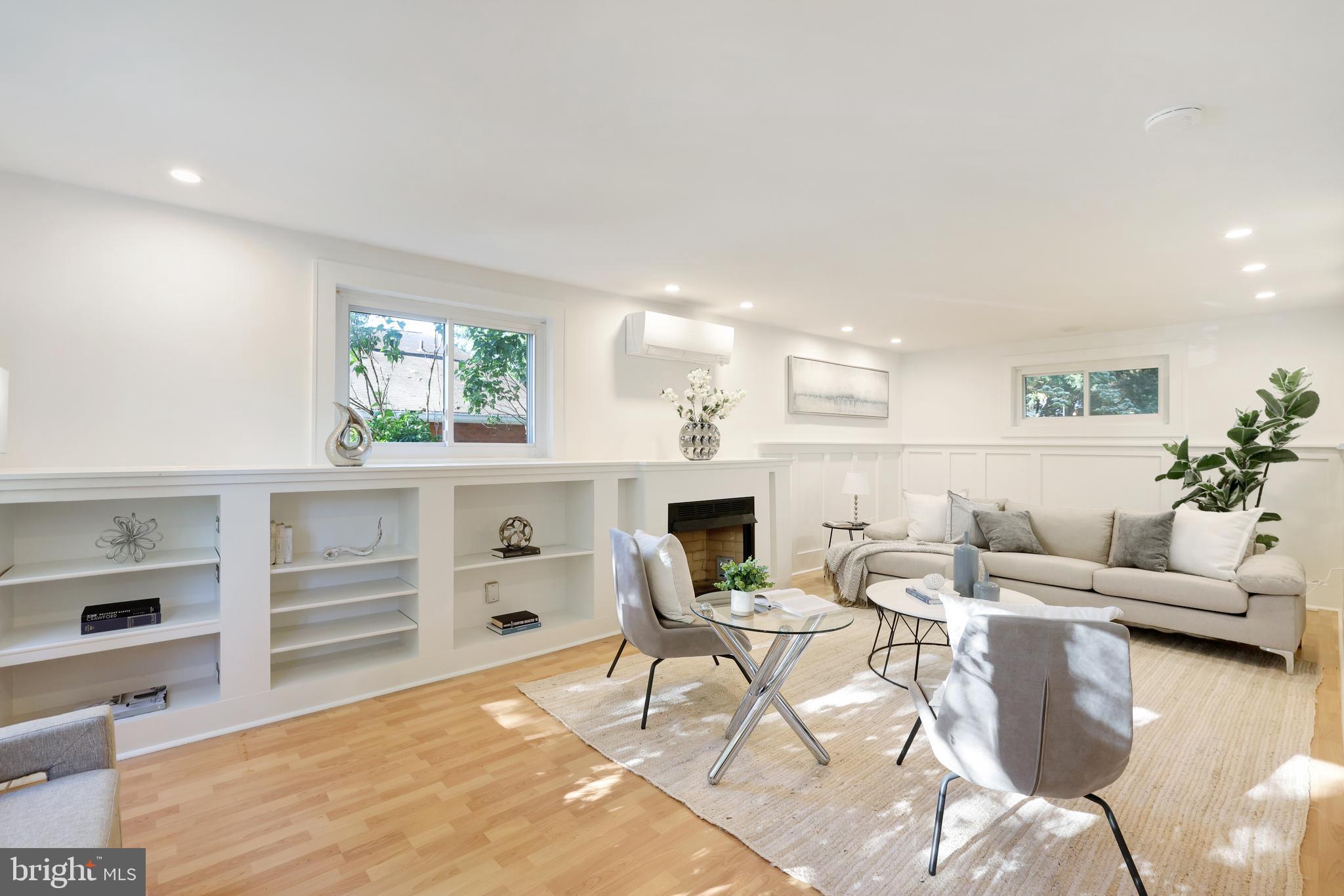 11812 Selfridge Road Silver Spring, MD 20906 - Photo 3 of 42 a living room with furniture a rug and a fireplace