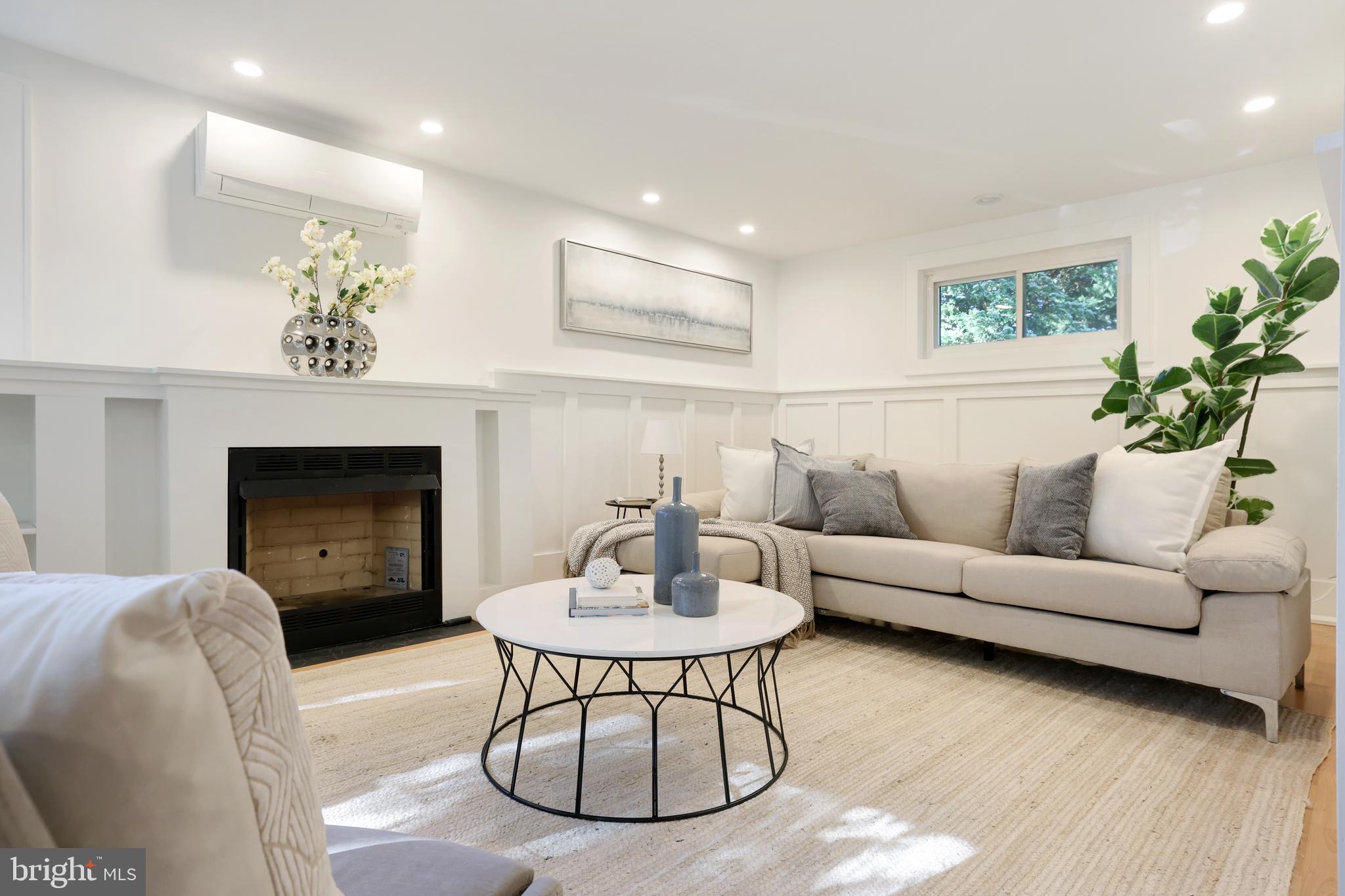 11812 Selfridge Road Silver Spring, MD 20906 - Photo 4 of 42 a living room with furniture a fireplace and a table