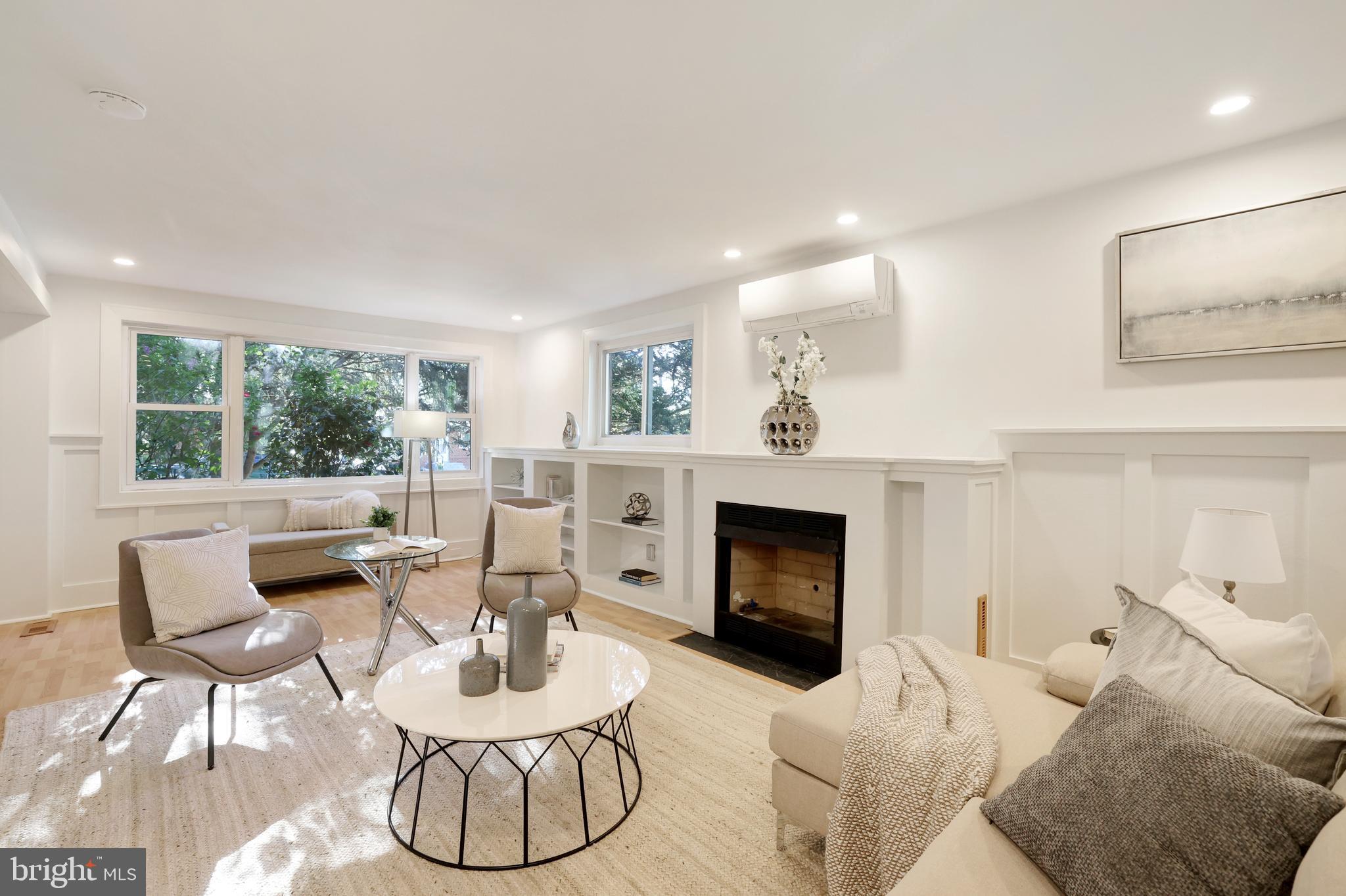 11812 Selfridge Road Silver Spring, MD 20906 - Photo 6 of 42 a living room with furniture a fireplace and a large window