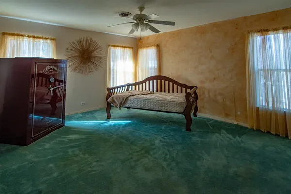 a view of a bedroom with furniture and windows