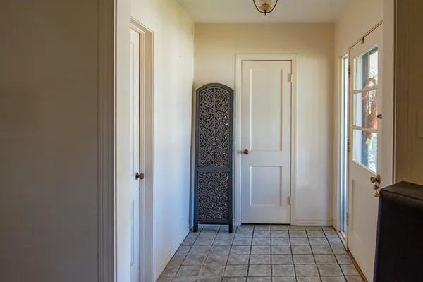 a view of a hallway with wooden floor and closet