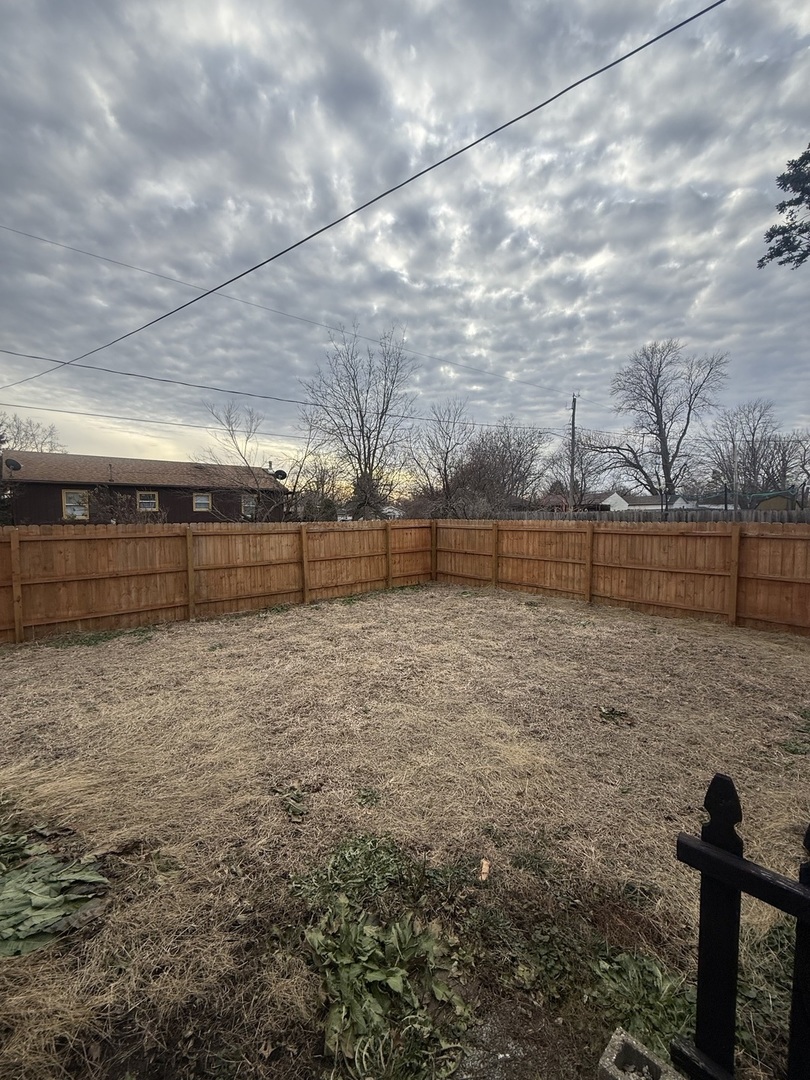 312 East 11th Street Georgetown, IL 61846 - Photo 19 of 25 a view of backyard with wooden fence