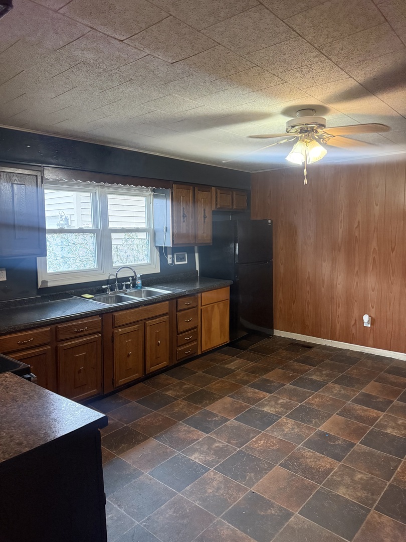 312 East 11th Street Georgetown, IL 61846 - Photo 5 of 25 a kitchen with stainless steel appliances granite countertop a sink and a stove