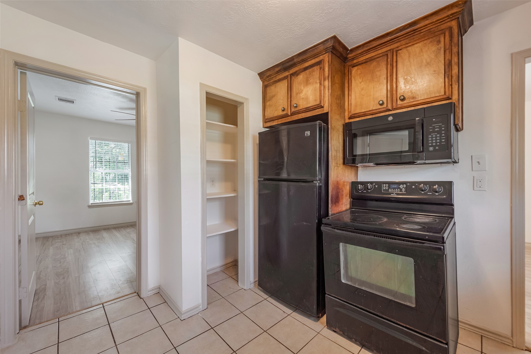 6402 West Montgomery Road, Unit A Houston, TX 77091 - Photo 12 of 23 a kitchen with granite countertop a stove and a refrigerator