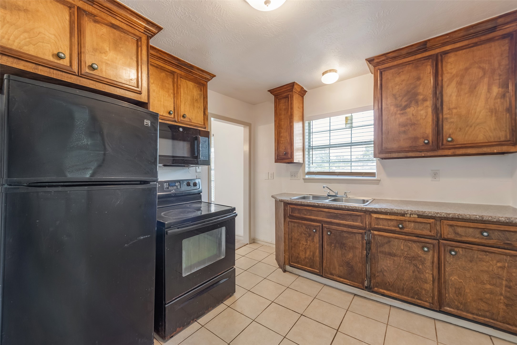 6402 West Montgomery Road, Unit A Houston, TX 77091 - Photo 13 of 23 a kitchen with stainless steel appliances granite countertop a refrigerator and a sink