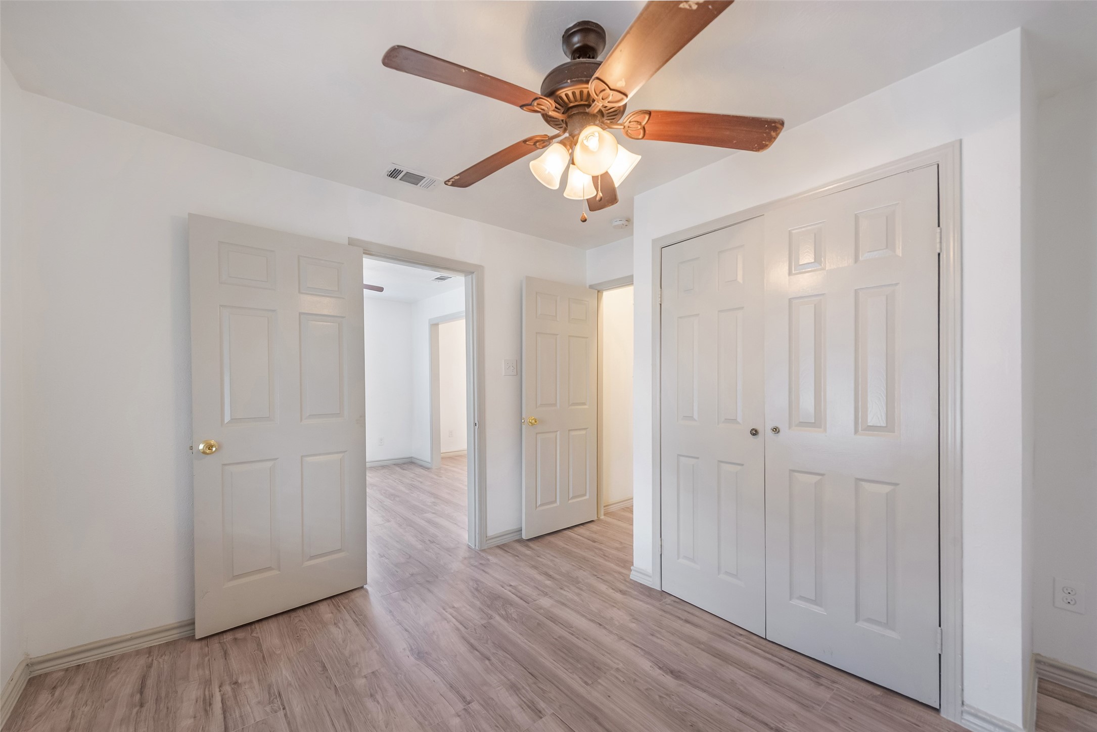 6402 West Montgomery Road, Unit A Houston, TX 77091 - Photo 21 of 23 an empty room with wooden floor fan and windows