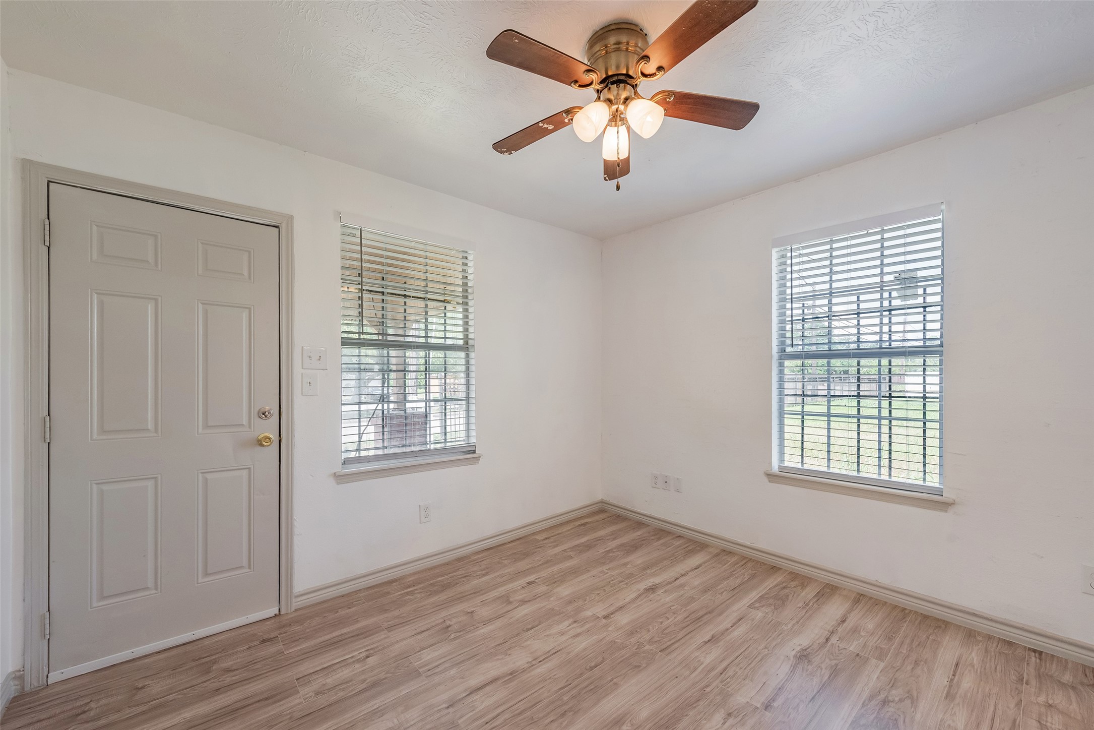 6402 West Montgomery Road, Unit A Houston, TX 77091 - Photo 6 of 23 wooden floor in an empty room with a window
