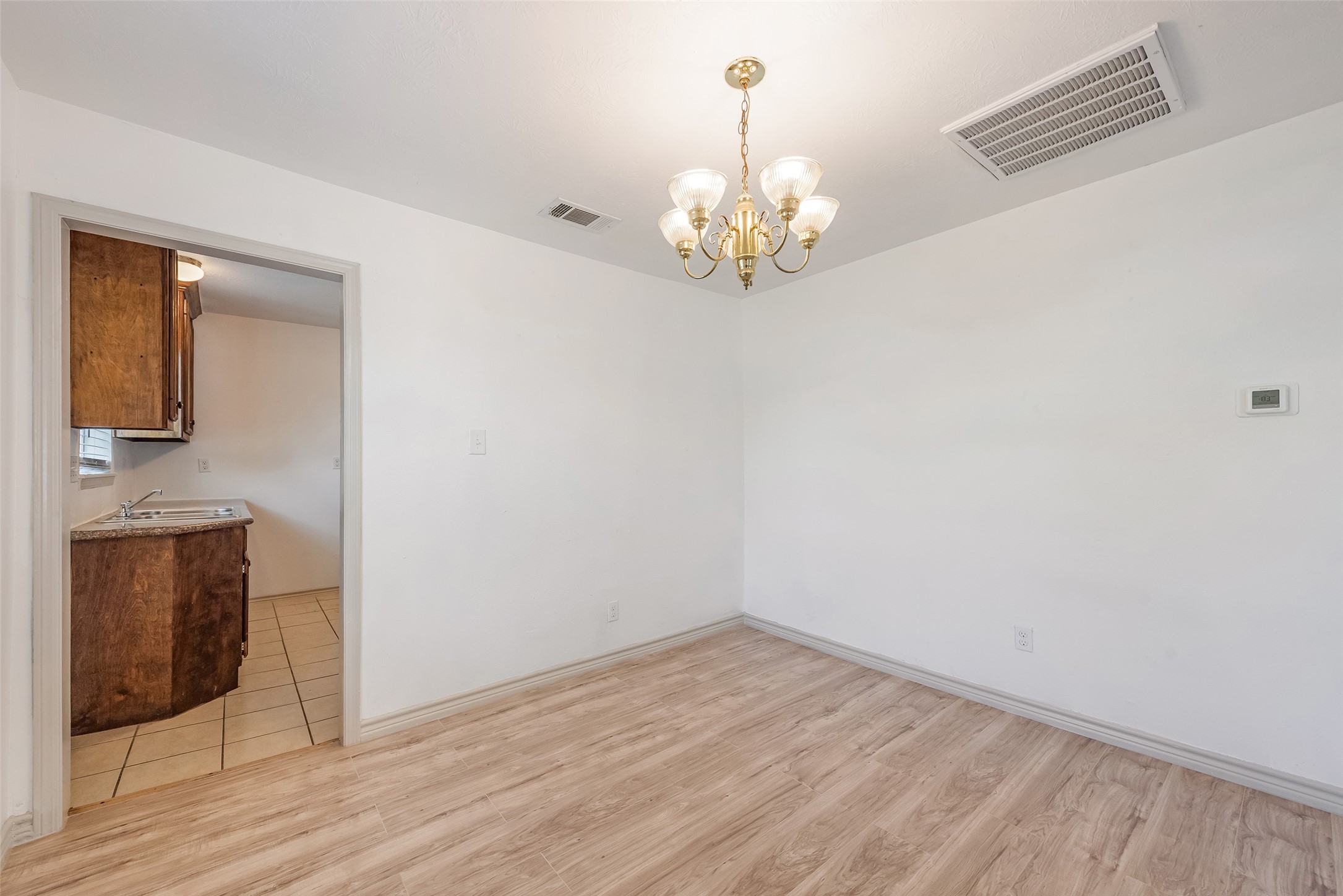 6402 West Montgomery Road, Unit A Houston, TX 77091 - Photo 7 of 23 wooden floor in an empty room with a window