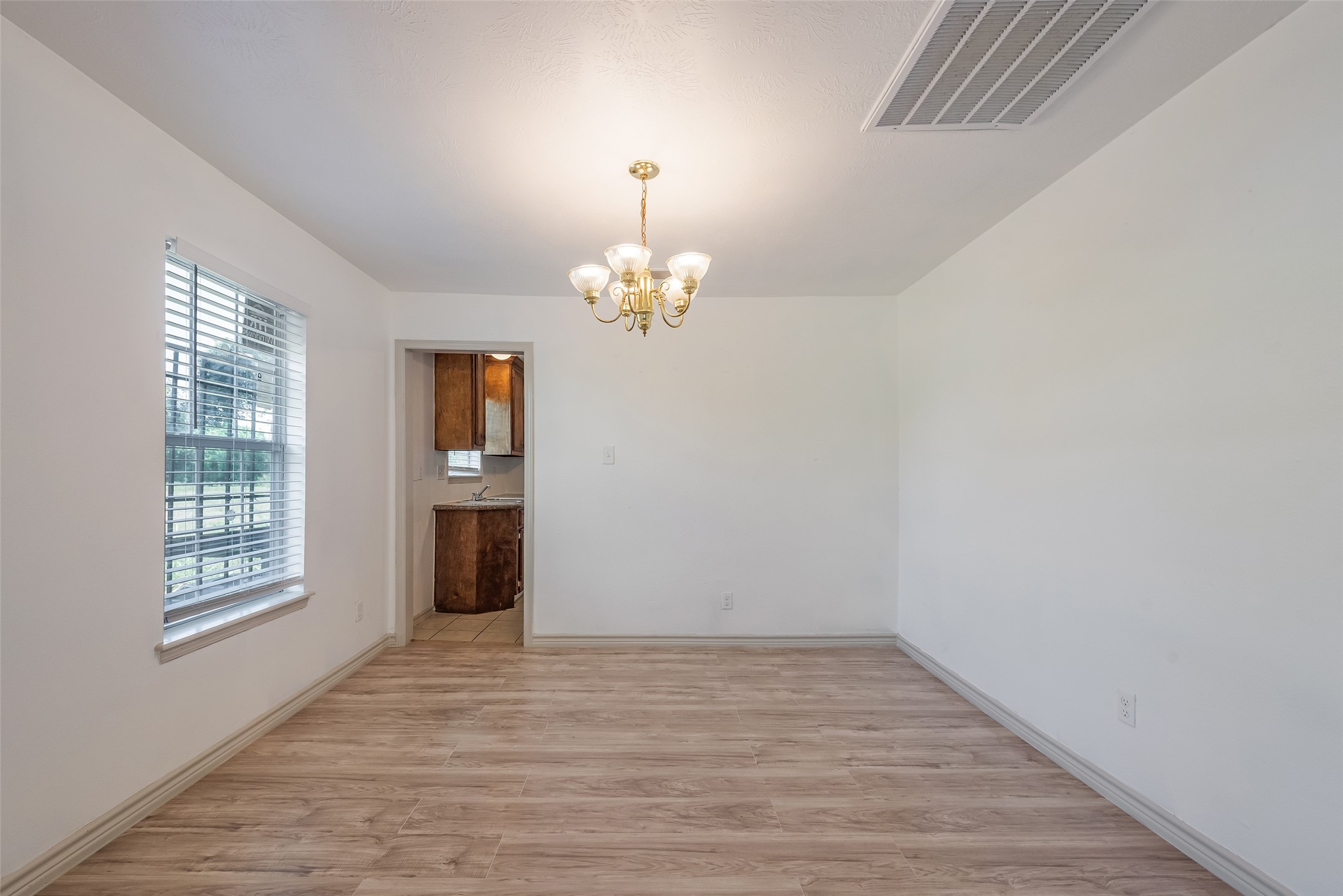 6402 West Montgomery Road, Unit A Houston, TX 77091 - Photo 10 of 23 wooden floor in an empty room with a window