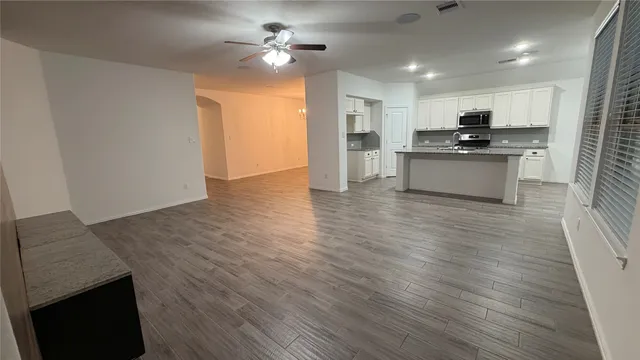 a view of kitchen with refrigerator microwave and stove
