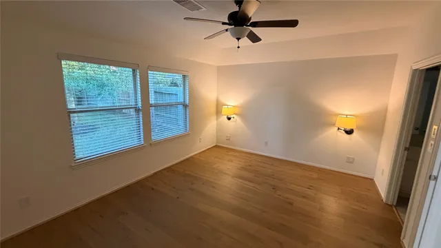 an empty room with windows and closet