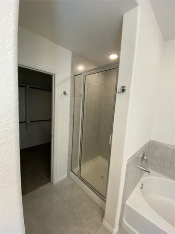 a bathroom with a shower and a sink