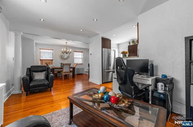 a living room with furniture and wooden floor