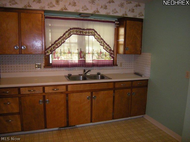6651 Engle Road Cleveland, OH 44130 - Photo 5 of 20 Kitchen sink has window with view of lovely pastoral yard. Curtains can stay.