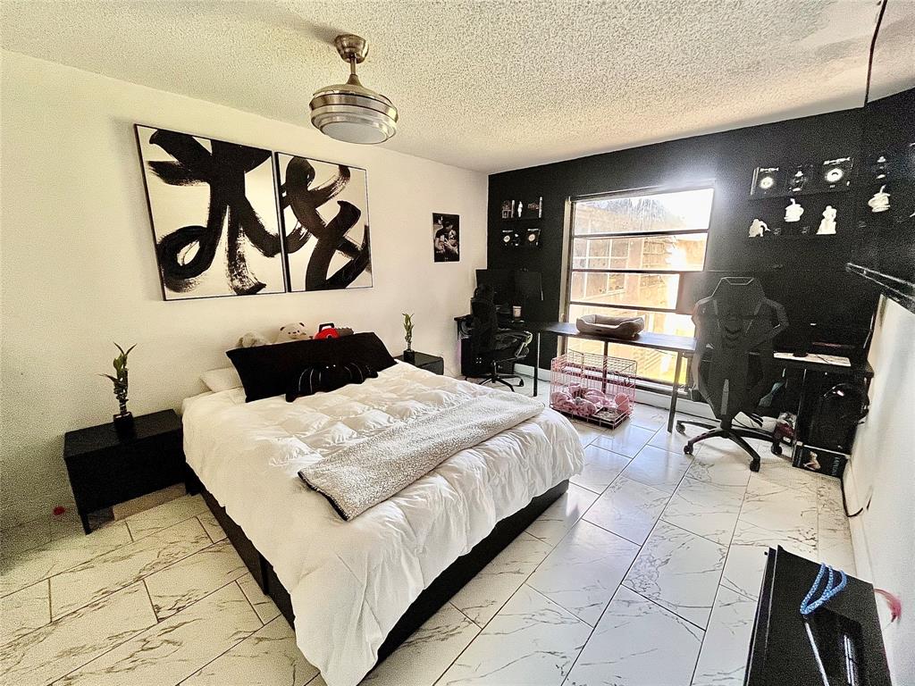 a bedroom with a bed mirror and window