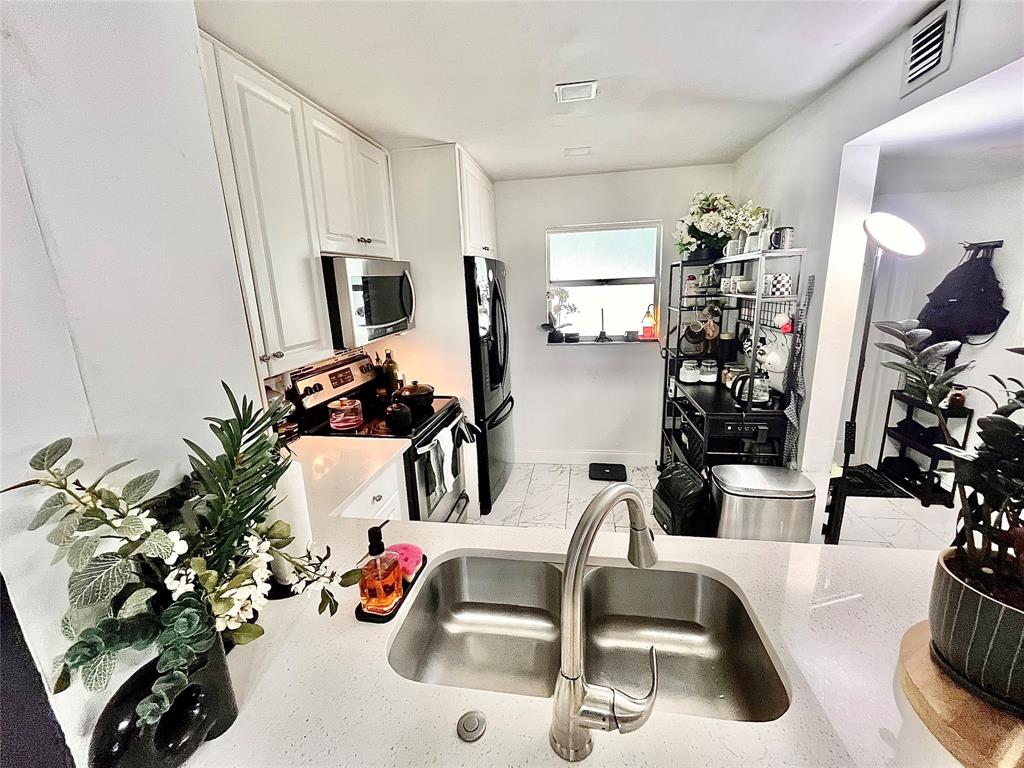 8301 Sands Point Boulevard, Unit 306S Tamarac, FL 33321 - Photo 7 of 10 a view of living room with furniture and a potted plant