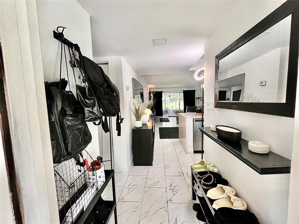 8301 Sands Point Boulevard, Unit 306S Tamarac, FL 33321 - Photo 8 of 10 a living room with furniture and a flat screen tv