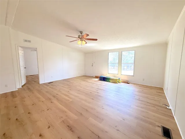 a view of a kitchen with a sink and wooden floor